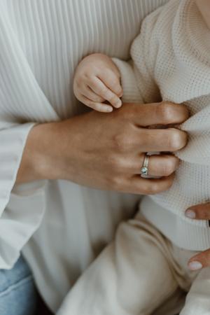 Image of women with a new born wearing personalized ring