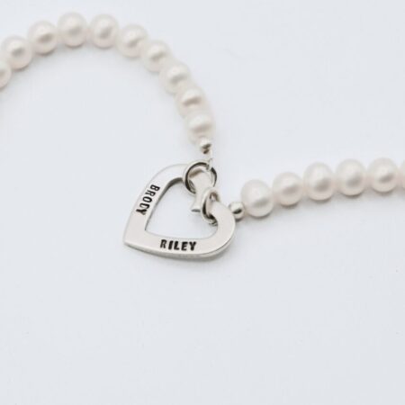Bracelet personalized with name on a heart charm made with Freshwater Peals