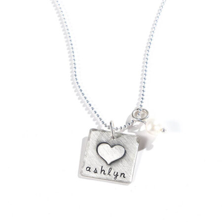 Sterling silver square with a heart fused on top with hand stamped name. Perfect personalized necklace for someone close to heart
