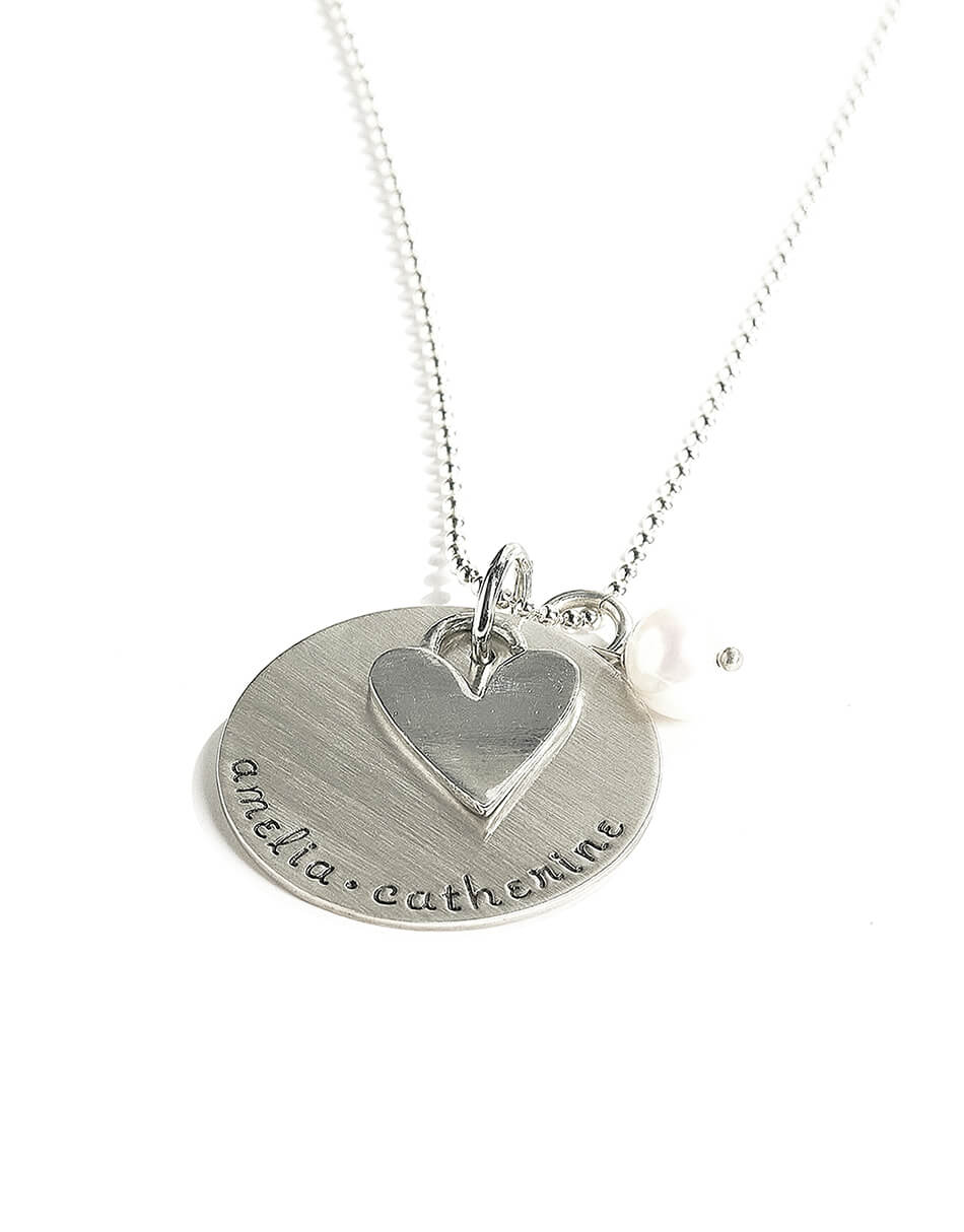 Hand stamped sterling silver disc along with a heart charm and a freshwater pearl. Perfect gift for mom, grandma
