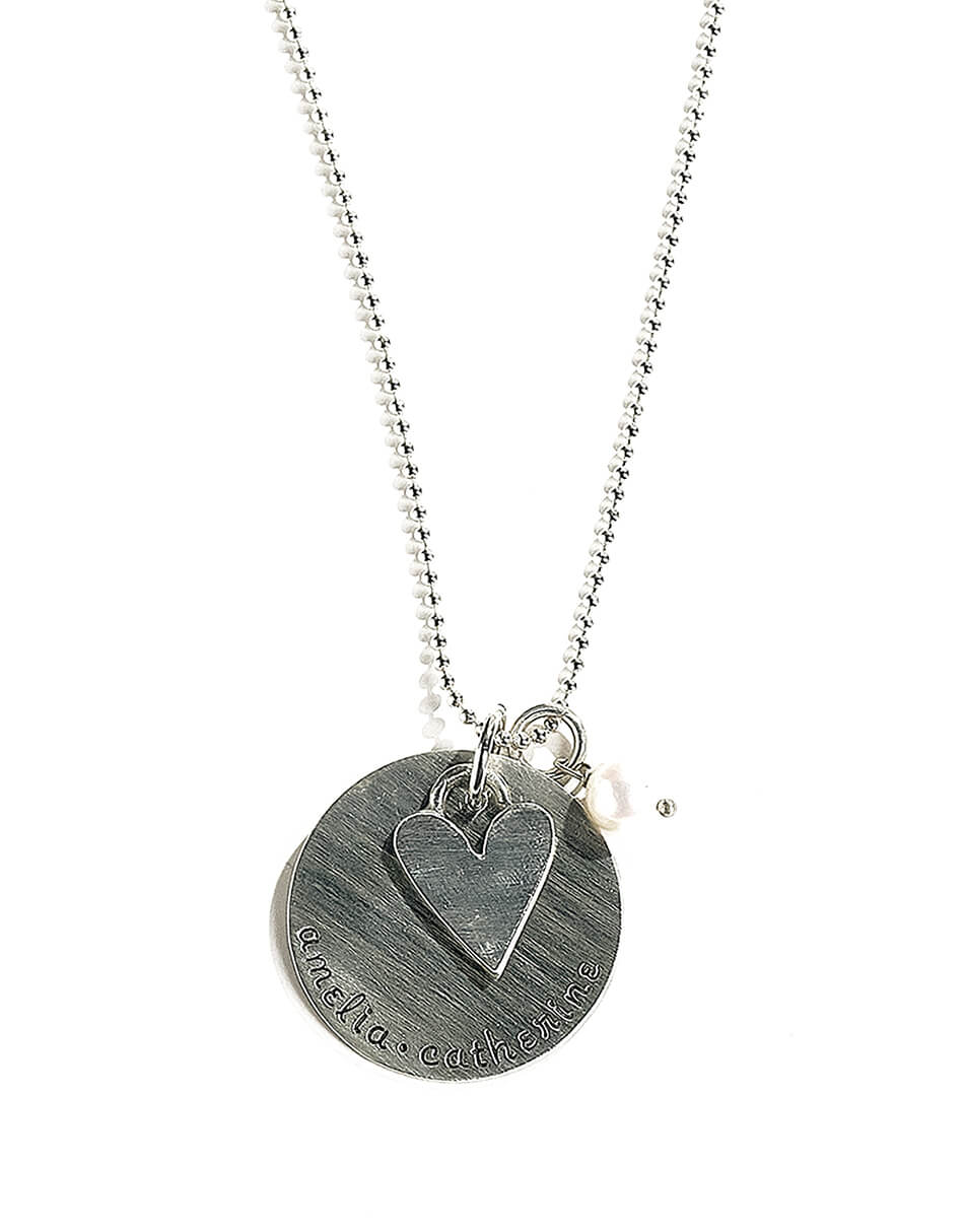 A sterling silver hand stamped disc along with a sterling silver heart charm and a fresh water pearl. Perfect gift for wife