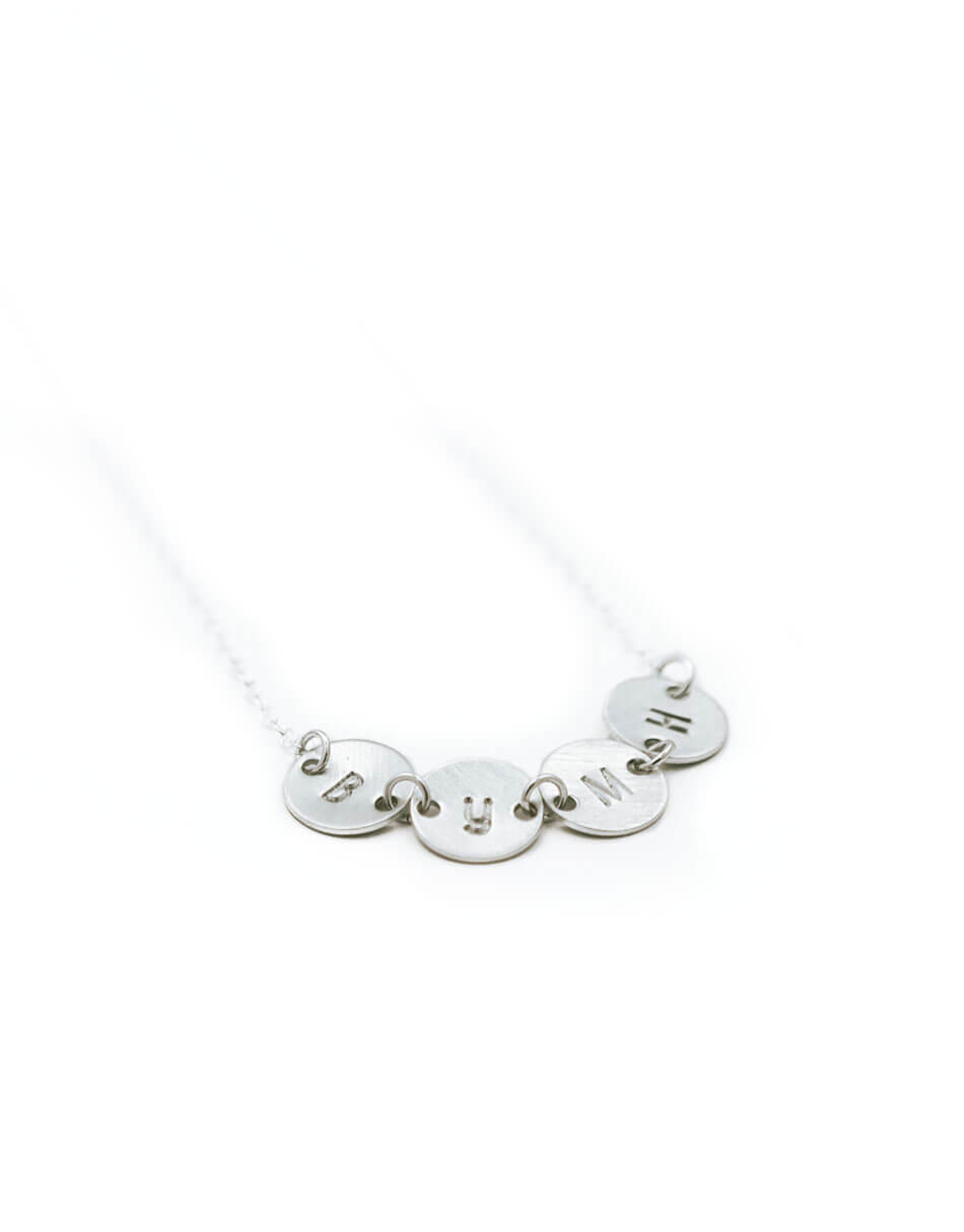 Dainty connected initial disc necklace in sterling silver. A sweet way to connect all of your loved ones together.