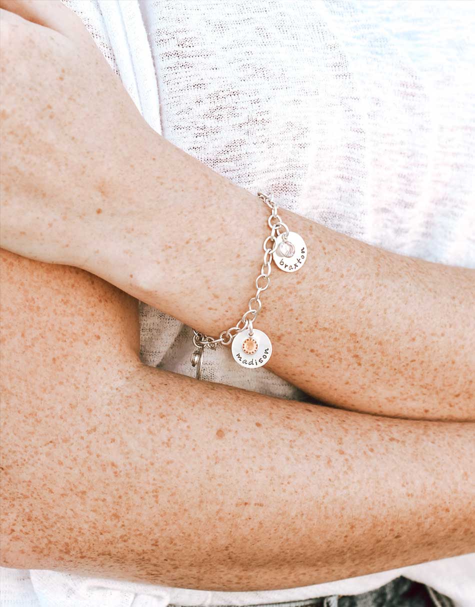 A beautiful Swarovski birthstone crystal drop hangs with each name charm. Perfect for Moms, grandmas.