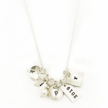 Sterling Silver Necklace with heart charm, circle charm, rectangle charm and square charm. 3 charms have Initial letter engraved and one charm has year engraved. Necklace has a pearl attached.