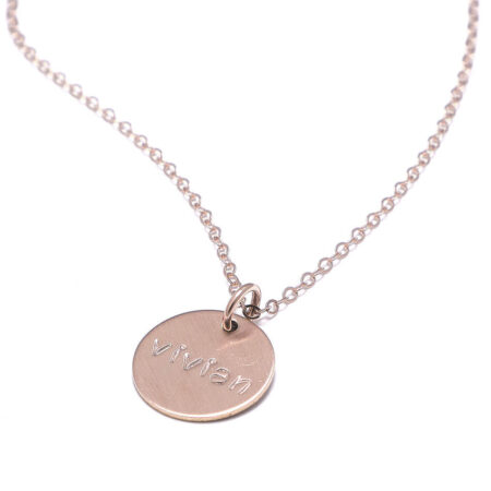 A dainty rose gold circle hung in the rose gold chain with engraved name. Gift this to a mom, sister or a friend.