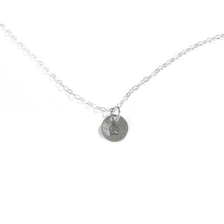 A beautiful sterling silver disc hand-stamped with the cutest little paw makes a great gift for a crazy dog lover.