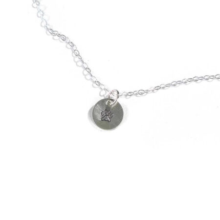 A beautiful hand-stamped sterling silver circle with the cutest little paw makes the best gift for a crazy dog lover.