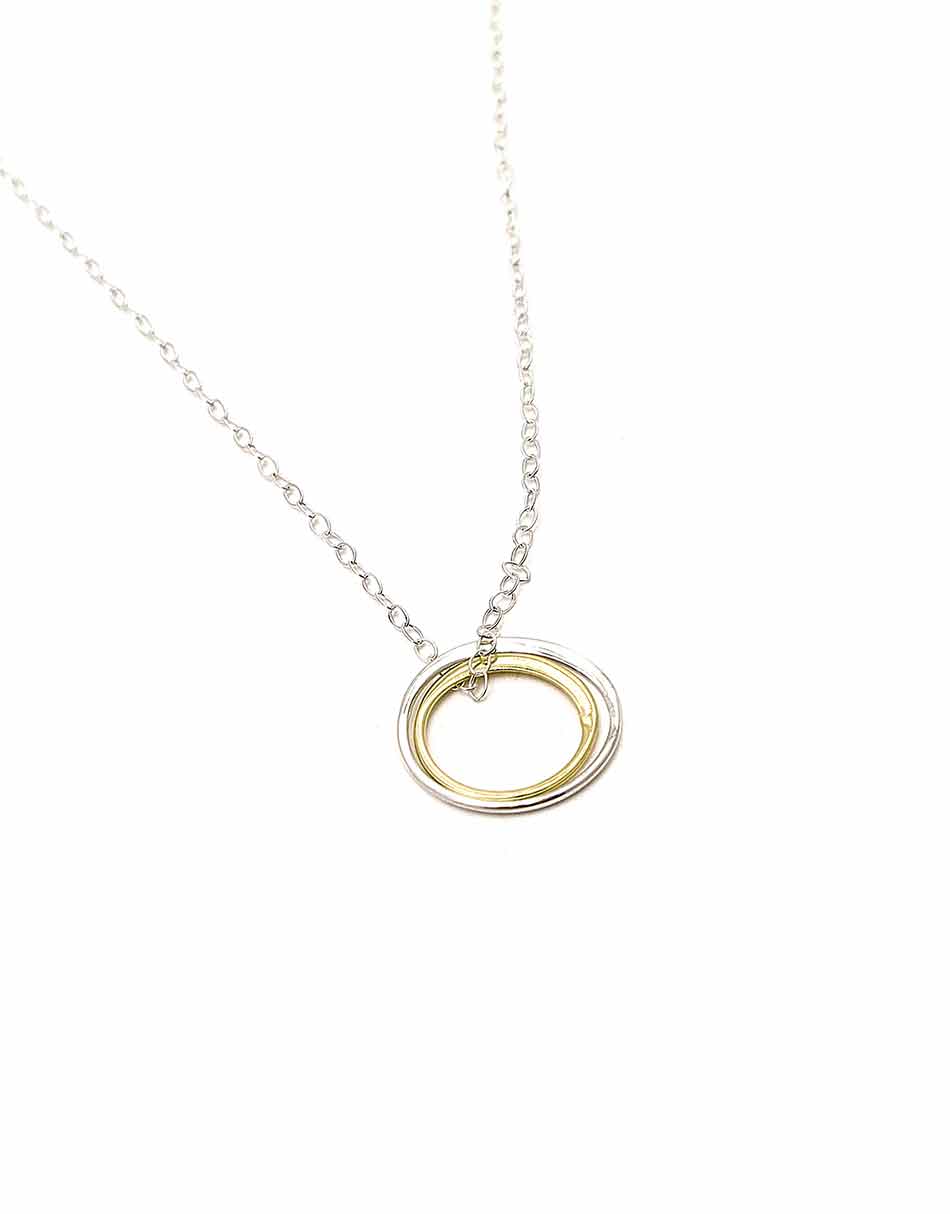 Made with a sterling silver circle and a gold-filled circle, hung on a sterling silver dainty chain. Perfect necklace for soul sisters.