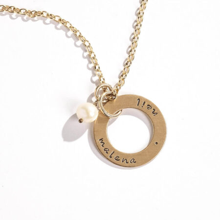A gold-filled circle with hand stamped names or dates. Perfect gift for wife, mom