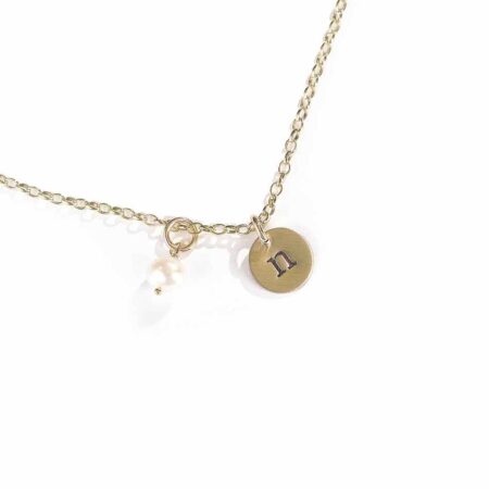 A dainty gold-filled disc with hand stamped initials. Personalized necklace to gift to wife, sister, daughter