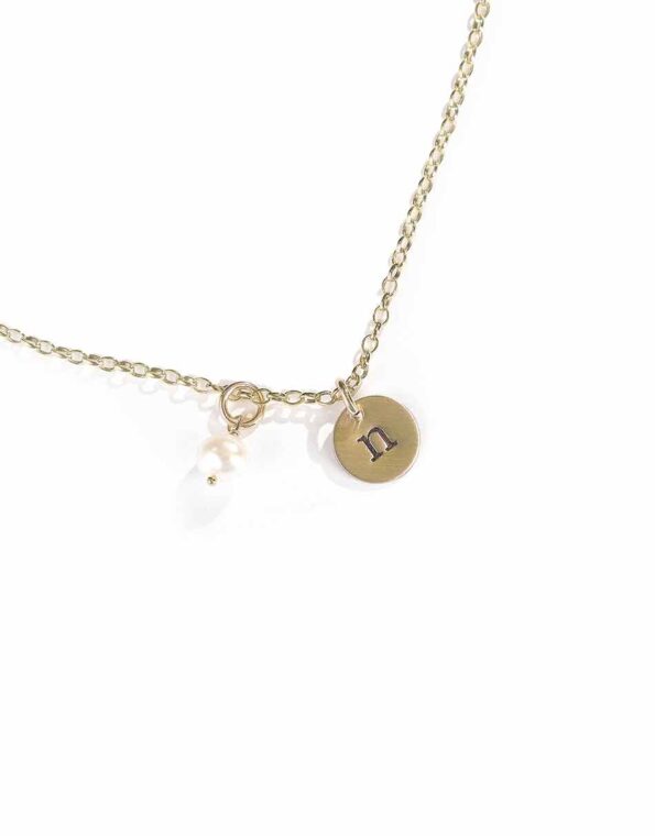 A dainty gold-filled disc with hand stamped initials. Personalized necklace to gift to wife, sister, daughter