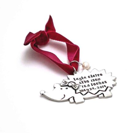 Made in fine pewter, up to 4 lines of text, hung on a velvet ribbon, and topped off with a freshwater pearl. Perfect Christmas gift for kids