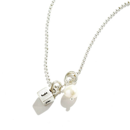 A dainty sterling silver square hand stamped on 4 sides with initials. Perfect gift for mom, wife