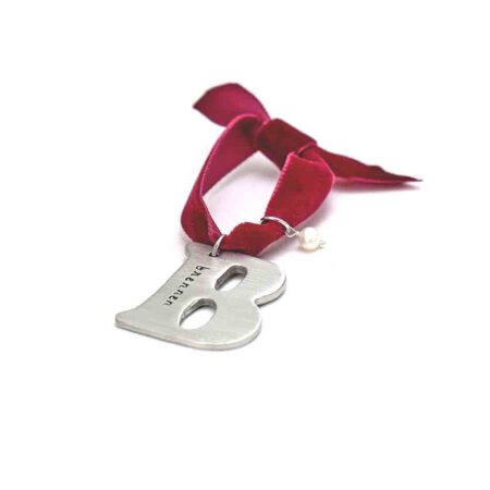 Fine pewter silver letter charm hung in a red velvet ribbon. Hand stamp with name or date. Best gift option for your loved ones