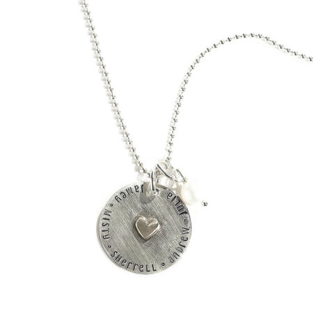 Sterling silver disc, hand-stamped with names, with a dainty sterling silver heart in the middle. Best personalized jewelry gift for wife
