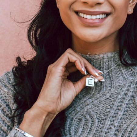 Women wearing Our Family Scrabble Tile Necklace