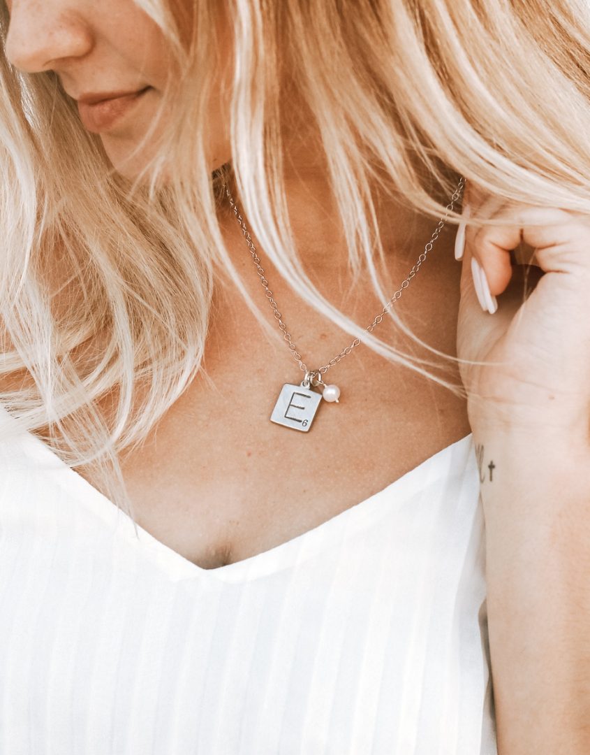 Women wearing Our Family Scrabble Tile Necklace