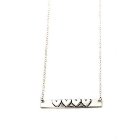 A sterling silver rectangle with hand stamped name on one side and hearts on other side. Personalized necklace for mom