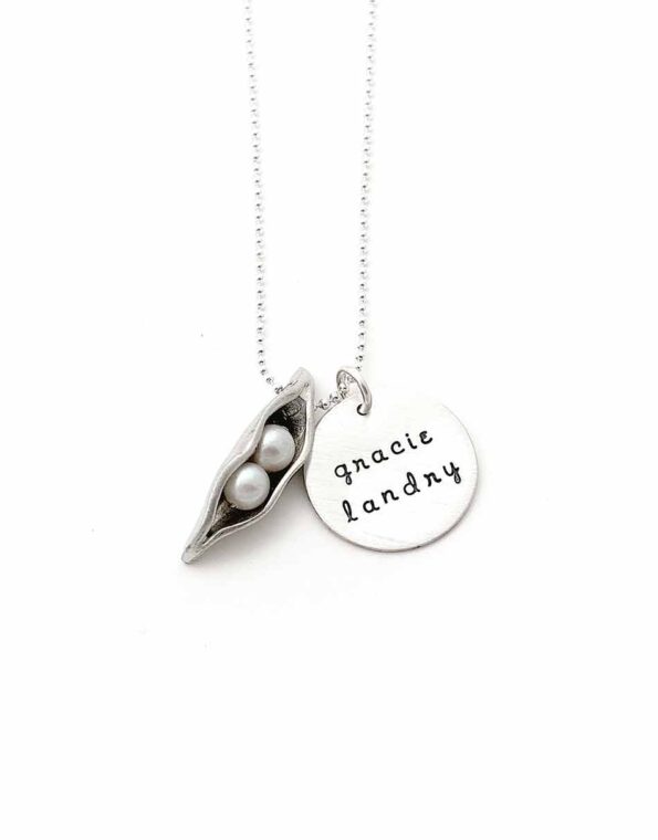 Best personalized gift for a mom. A pea pod with fresh water pearls representing her kids. A disc with names of the kids hand stamped on it.