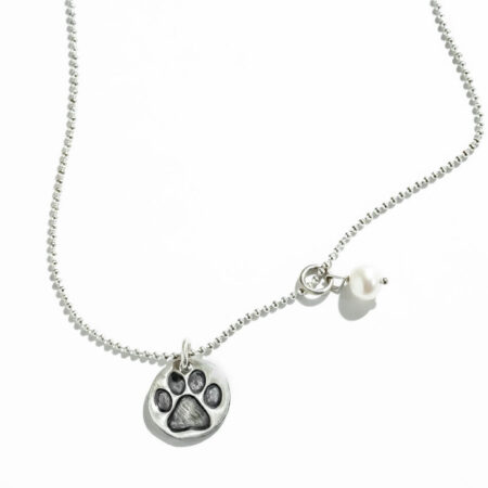 Perfect gift for dog lovers. A sterling silver disc with paw print and a freshwater pearl