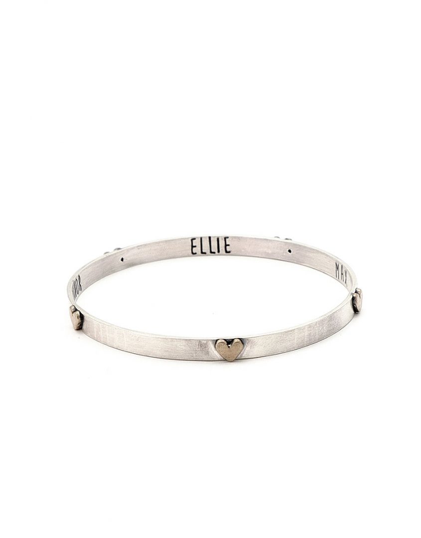 A beautiful bangle with 5 hearts on it. Get the names of your loved ones hand stamped on the inside of the bangle.