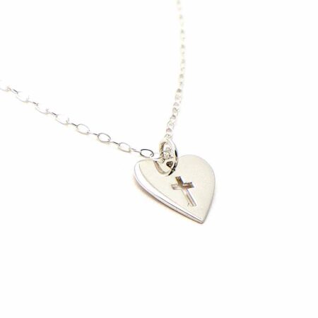 A sterling silver heart charm with a lovely cross cut out in the middle of it, hung on a sterling dainty chain. Perfect for girls of any age